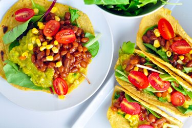 Corn tortillas filled with avocado and beans