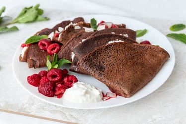 Spelt chocolate crepes with ricotta and hot raspberries